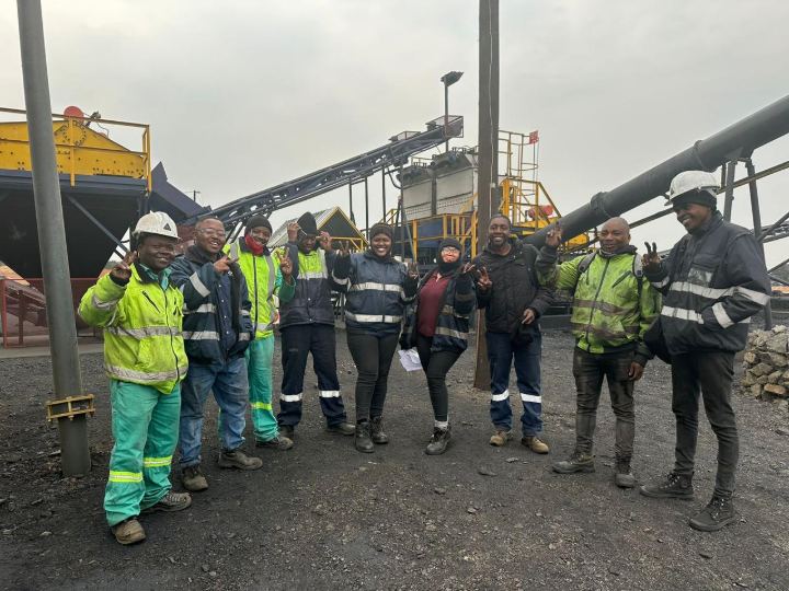 The G8 crew in PPE on site in front of the plant
